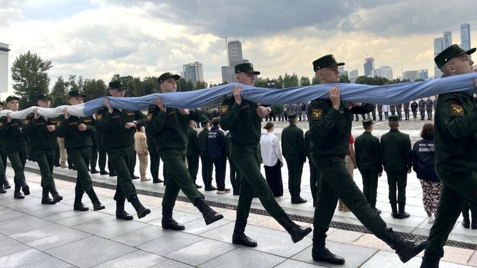 Soldiers carrying the flag - flag day at museum