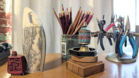 Jen Rose Smith Gotauco engraves nautical scenes onto whale teeth in her New Bedford studio (Credit: Jen Rose Smith)